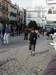 Playing soccer with an orange in Plaza del Salavador (the crowd is mostly drinking glasses of beer from one bar)