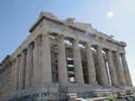 The Parthenon.  This picture doesn't do it the faintest justice.  The Parthenon seems both solid and light simultaneously.  Though everything about the outside columns appears vertical and solid, there is acually no straight, vertical line in the whole thing.  Each vertical is almost imperceptibly bowed to a vanishing point some 11,500 feet in the sky. The columns get thinner toward the center of the colonnade and the space between them gets smaller. They also lean slightly toward the center.  We think we can see these differences but we're not sure.  The Turks used the Parthenon as a powder magazine, when, on September 26, 1687, Venetian artillery scored a direct hit. The Venetians tried to lower tried to swipe Athena's horses from the pediment, but they goofed and the horses smashed the rock below. The Turks regained possession of the Acropolis the following year and later began selling souvenirs to Europeans, including the Duc de Choiseul and Lord Elgin. Elgin took home 50 pieces, the "Elgin Marbles," most of the remaining Parthenon sculpture.  He later sold them to the British Museum for 35,000 pounds. (Elgin's shipping charges were 75,000, a huge sum for those days.) 