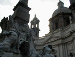 There's a legend that Bernini hated the facade of the church of S. Agnese in the background.  The facade was designed by a former student and rival of Bernini, Borromini. This explains that the statue of the Nile River hides its head to avoid seeing the Borromini facade, and that of the Río de la Plata raises its arm in alarm to prevent the building from falling. The fountain was, in fact, unveiled in 1651, a year before the church of S. Agnese was begun, two years before Borromini was called in.