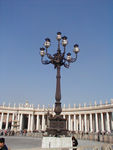 The Square is really an ellipse.  It was designed by Bernini.  At the center of each side of the collonade, the columns "line up, " i.e. the three outside sets disappears behind the front set.  