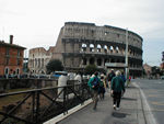Old Colosseum and young tourists 