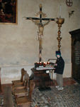 Maggie lighting a candle in St Donato