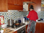 Monica cooking a great meal in the kitchen of our new apartment
