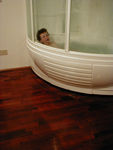 Maggie in the apartment's space capsule-like bathtub/shower