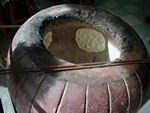 Butter naan, a kind of Indian bread, baking in a jar-shaped oven.  Kuala Lumpur is home to large Malay, Chinese, and Indian populations.  