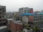 Out the window of the YMCA in Xian.  Xian seems to be in the midst of an urban renewal binge.  Whole blocks have been flattened.  Xian has many fewer English signs than Chengdu but, it seems like, as many boutiques and mini-skirts.