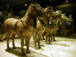 A half-size set of bronze horses pulling one of two chariots found in another place related to Shih huang-ti's tomb.  Shih huang-ti was emperor of the Ch'in dynasty (221-210/209 BC) and the first to unify China. He ascended the throne at age 13, in 246 BC.  By 221, with the help of espionage, extensive bribery, and the ruthlessly effective leadership of gifted generals, Shih huang-ti had eliminated one by one the remaining six rival states that constituted China at that time.