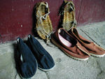 Footwear.  Against the wall are woven shoes sold by some of the shops lining the path and worn by many pilgrims.  The snappy set on the right is from a monk.