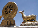 The wheel of dharma and deer, supposedly commemorate Buddha's preaching in a deer park.
