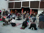 Worshippers in front of the Jokhang.  The women put a band around their calves and usually had small cardboard pads for their hands.  
