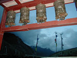 Prayer wheels and prayer flags in the background