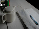 Tea pot and the ledger in which the owner keeps track of what guests have ordered
