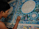 Painting a thanka, a mandala used for meditation and sold to tourists in Pokhara.