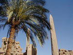 The obelisk on the left is one of the Obelisks fo Hatshepsut.  Tuthmosis III attempted to eradicate all signs of the reign of Queen Hatshepsut, his step-mother, and built a 25 meter tall stone structure around this obelisk to hide it.   It is the tallest obelisk in Egypt and the top half was orignially covered with electrum, an alloy of gold and silver.  
