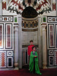 Maggie, wrapped in the robe the Mosque provides improperly clad women visitors, in a mihrab - a semi-circular niche which show the direction to Mecca.  (Monica needed the green outfit, because she came with bare shoulders. )