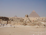 Sphinx and pyramid of Menkaura on its right and pyramid of Khafra on its left.