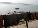 Adjacent to the swimmers along this section of the Ganges, is the laundry.  These guys rub and sling clothes against flat rocks at the River's edge.  Just to their right there are bodies being covered with wood and cremation bonfires
