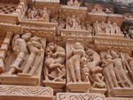 This is a typical sculpture group for the Khajuraho temples.  One guidebook marvels that the kings of the Chandela could build somewhere around 85 temples between 950 to 1050.  Perhaps the secret was mass production.  There are many many  images on each of the temples that we visited but generally the individual pieces are virtually identical.  Every now and then, there is a different pose or a particularly well-executed version of a standard pose.  Despite the repetition, the  sculptures are lovely and seen together rather unbelievable.