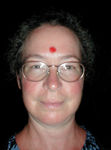 Monica with a bindi placed on her forehead by the "priest"