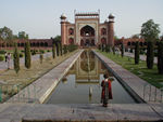 Maggie looking back at the main gate - the mausoleum is behind her.  The garden is called a classic Mughal garden - long water courses and pools with walking paths, fountains, and ornamental trees.  It is similar to that inside the Red Fort. 