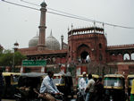 The south gate of the mosque with autorickshaws waiting.  The ones with green stripes are CNG powered.  Eventually, we climbed the tower on the left.