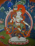 Goddess holding up one of the  8 religious symbols of Tibetan Buddhism.  This is the banner (it looks like an umbrella) of Victory.  It heralds the triumph of Buddhist wisdom over ignorance.