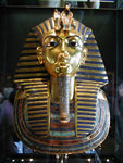 Funerary Mask of Tutankhamun.  From his tomb in Valley of Kings, near present-day Luxor.  King Tut's mummy was placed in three nested coffins.  The innermost coffin was made of solid gold and weighs around 240 pounds.  This mask covered the mummy's head and shoulders.  Since the king's face was wrapped, the mask would let the king be recognized in the hereafter.  On the king's brow are the head of a vulture and the sacred asp, the symbols of Upper and Lower Egypt.  