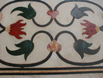 As embodied in the Mughal craft, pietra dura incorporates the inlay of semiprecious stones of various colours, such as lapis lazuli, jade, crystal, turquoise, and amethyst, in highly formalized and intertwining geometric and floral designs. The colours serve to moderate the dazzling expanse of the white marble. 