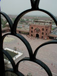 Looking down at the courtyard of the mosque from the tower.  In this picture and the next, one can see the Red Fort in the distance